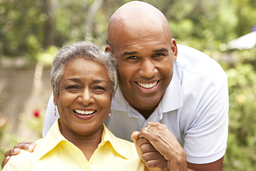 African american mother and son holding hands outside smiling